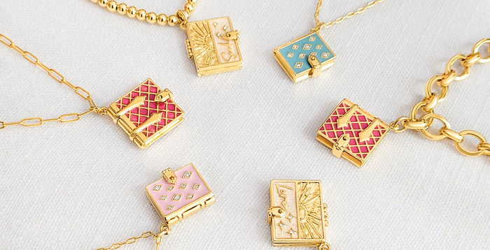 Magenta Secret Diary Book Locket, Blush Stardust Book Locket, Love Secret Scriptures Locket, Magenta Secret Diary Book Bracelet, and Seek Secret Scriptures Bracelet all in a circle.